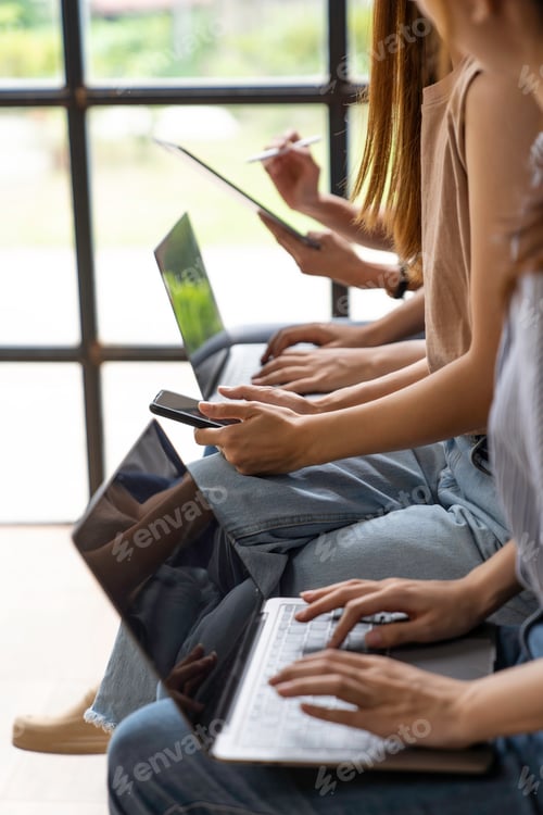 Preview: Beautiful Asian woman using smartphone, laptop and tablet in office during office meeting