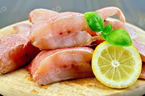Preview: Fillet of sea bass with lemon and basil on board
