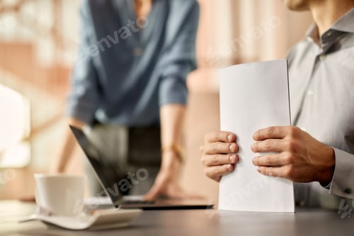 Preview: Close-up of male entrepreneur with business reports in the office.