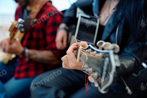 Preview: Musicians playing guitars in a cozy indoor setting during a casual jam session