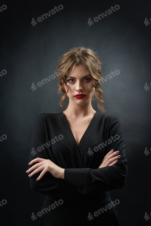 Preview: Confident woman wearing red lipstick posing in front of camera
