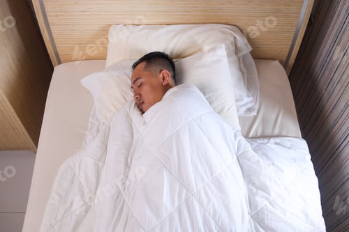 Preview: Man sleeping wrapped with white soft blanket