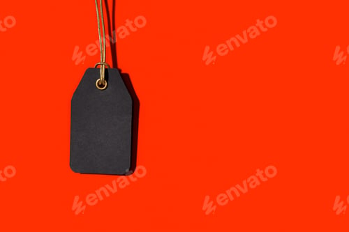 Preview: Blank black tag isolated on red background with copy space