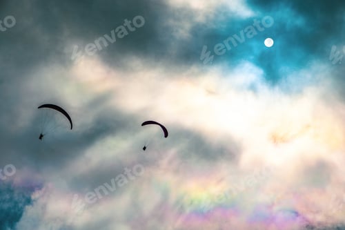 Preview: People try paragliding flying with parachutes against clouds