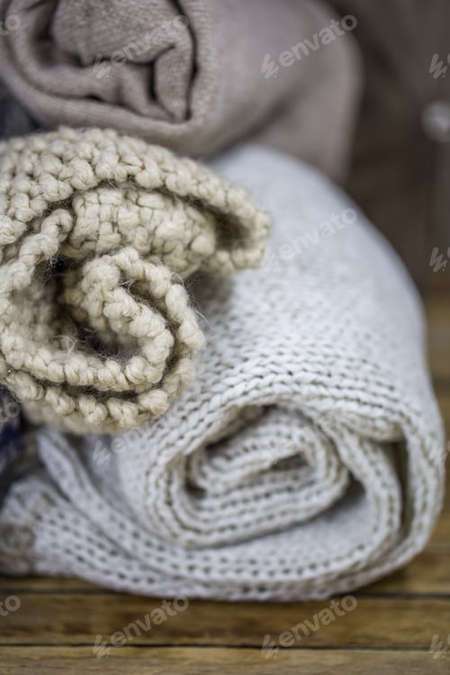 Preview: Sweaters on wooden background