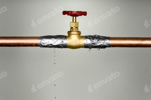 Preview: Closeup shot of the leaking water pipe with red valve
