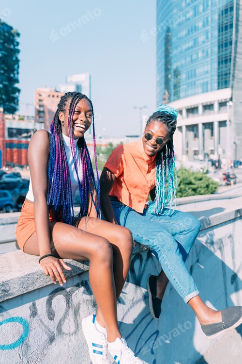 Preview: two women sisters sitting outdoor having fun together