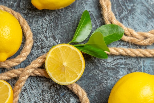 Preview: top view fresh lemons with ropes on a light-dark background citrus fruit photo colors