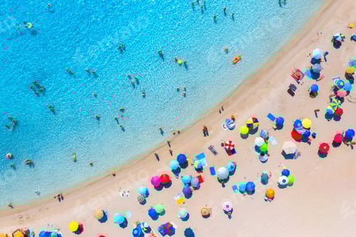 Preview: Aerial view of colorful umbrellas on beach, people in blue sea