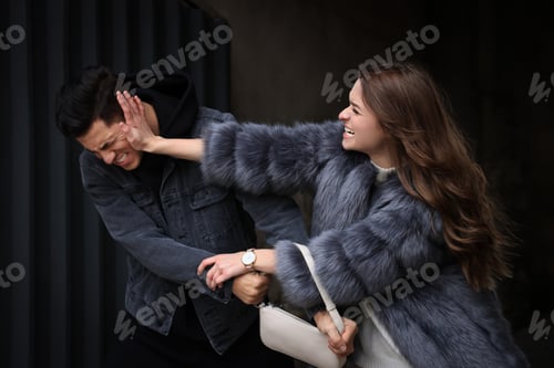 Preview: Woman fighting with thief while he trying to steal her bag in alley. Self defense concept