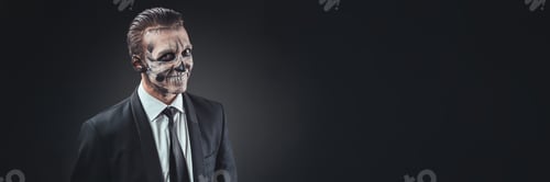 Preview: Man with Skull Face Paint Business Attire Wide Banner