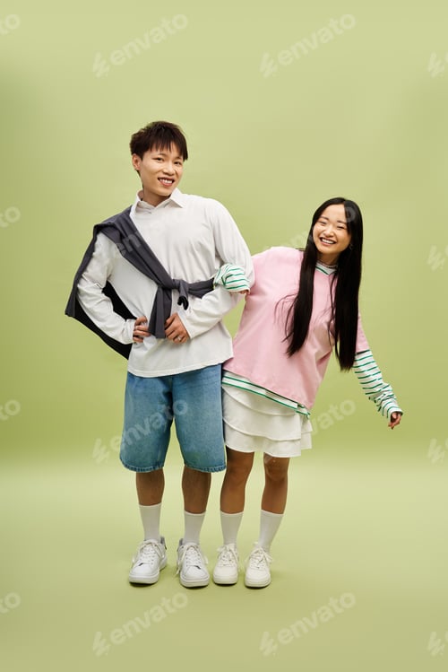 Preview: Stylish couple having fun together while showcasing their fashionable outfits in a playful moment