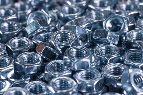 Preview: Metal chrome nuts in a chaotic order industrial background