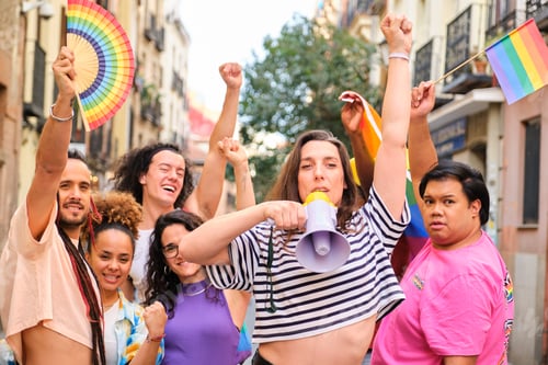 Preview: LGBTQ people with rainbow flags and a megaphone fighting for their rights.
