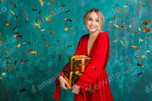 Preview: woman in red dress celebrating new year holding presents