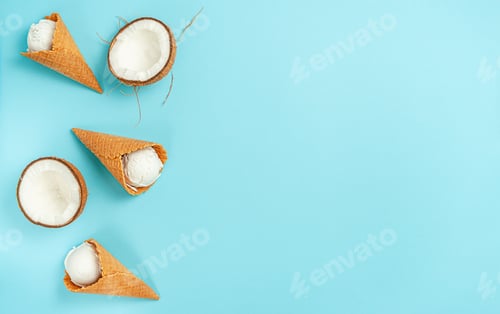 Preview: Organic coconut ice cream cones on bright blue background. Flat lay, copy space.