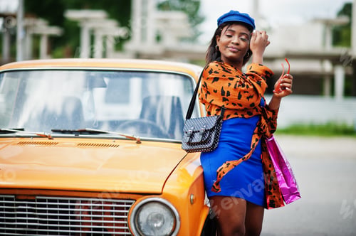 Preview: African american lady near orange classic retro car