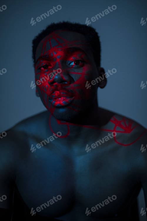 Man Posing with Red Painted Face and Body