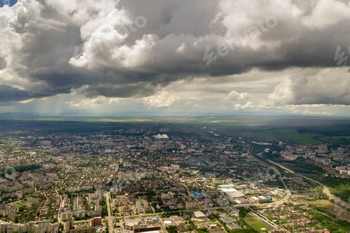 Preview: Aerial view of town or city with rows of buildings and curvy streets in summer.
