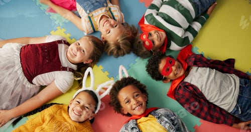 Preview: Happy children, friends and costume in class above on floor for dress up or casual day at school. T