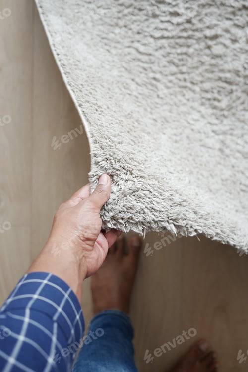 Preview: men rolling out new rug.
