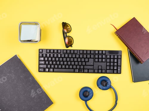 Preview: Top view of keyboard, folder and headphones
