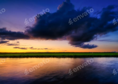 Preview: Seascape during sunset. Sunshine. A huge cloud in the sky after a storm.