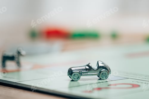 Preview: KYIV, UKRAINE - NOVEMBER 15, 2019: Selective focus of playing figure on monopoly game on table