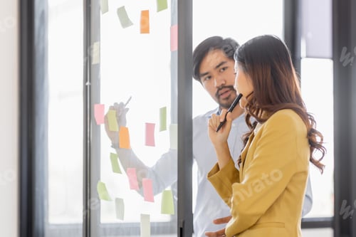 Preview: Team of Business female employee with many conflicting priorities arranging sticky notes commenting