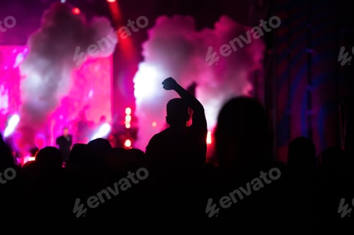 Preview: Abstract photo of crowd at concert and blurred stage lights.