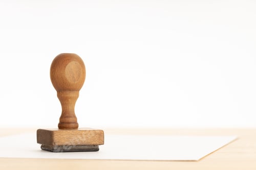Preview: Vintage Rubber stamp and blank paper on wooden table