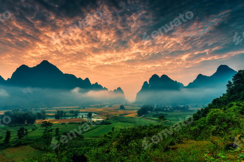 Preview: Landscape of vibrant sunrise over mountain range with foggy, river in Phong Nam Valley