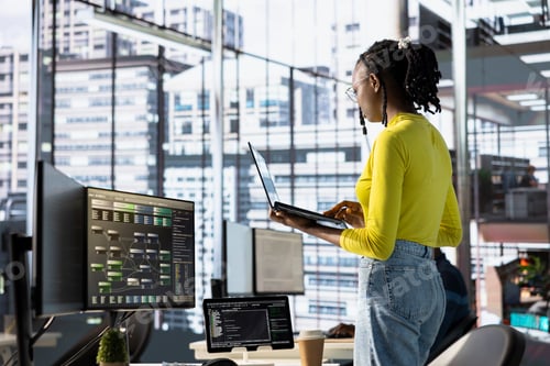 Preview: Woman transforming data into predictive models using notebook in office
