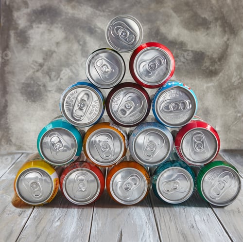 Preview: Drinks in cans stacked in a pyramid on the table.