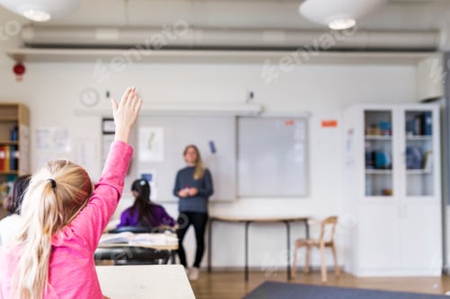 Preview: Young Girl Raises Hand in Classroom at School