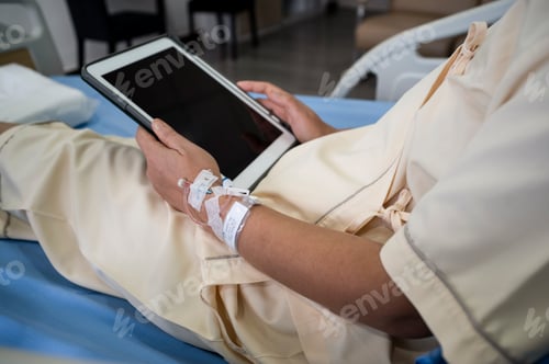 Preview: Middle-aged Asian female patient recovering from illness in hospital room, health care concept.