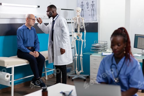 Preview: Doctor Checking Patient Temperature in Medical Clinic