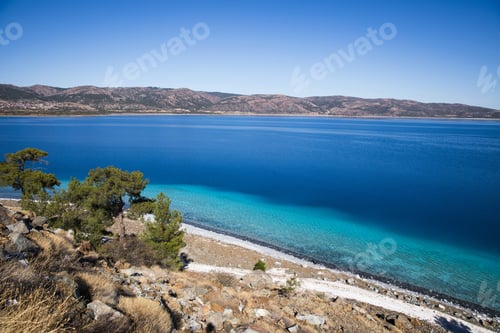 Preview: beautiful landscape with calm blue water and rocky coast, salda golu, turkey
