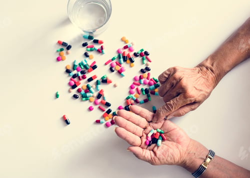 Preview: Closeup of hands taking pills health treatment isolated