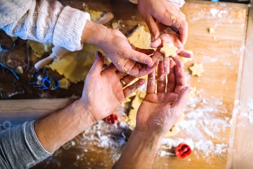 Preview: Young family making cookies at home.