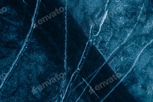 Preview: Beautiful lines on the blue frozen surface. Aesthetic background.