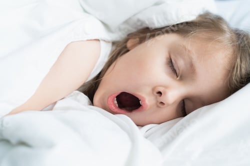 Preview: Little snoring girl, sleeping on pillow in bed with closed eyes. Evening late going to bed. Bedtime