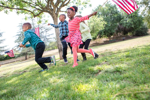 Preview: Children playing with American flag in park