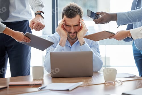 Preview: Shot of a young businessman feeling stressed out in a demanding office environment at work
