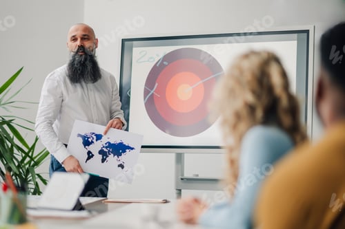 Preview: Marketing executive explaining global strategy during a business meeting