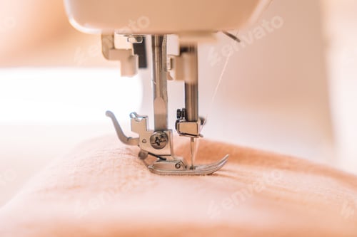Preview: Close-up of a foot from a white sewing machine