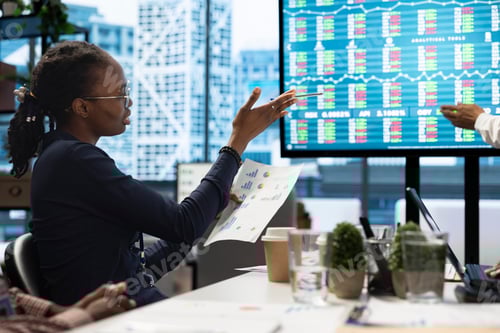 Preview: Diverse management team evaluates budget reports on interactive board