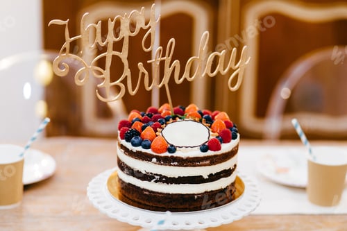 Preview: cake for birthday party standing on wooden table. Table served for celebration birthday
