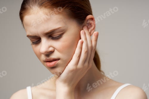 Preview: sick woman poor hearing disorders in white t-shirts light background