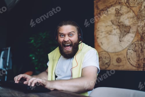 Preview: Mad young guy shouting at camera while playing computer game